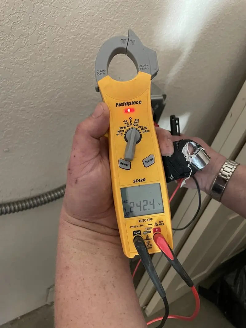 Voltage testing with clamp meter during Outlet Installation in Portville
